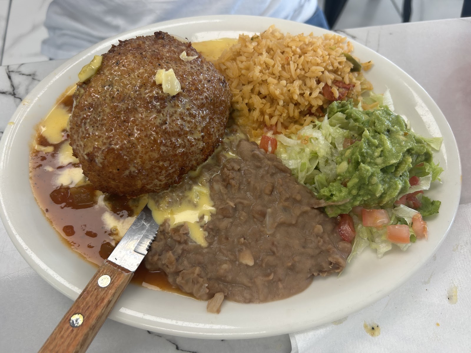 Chile relleno plate with rice, beans and guacamole