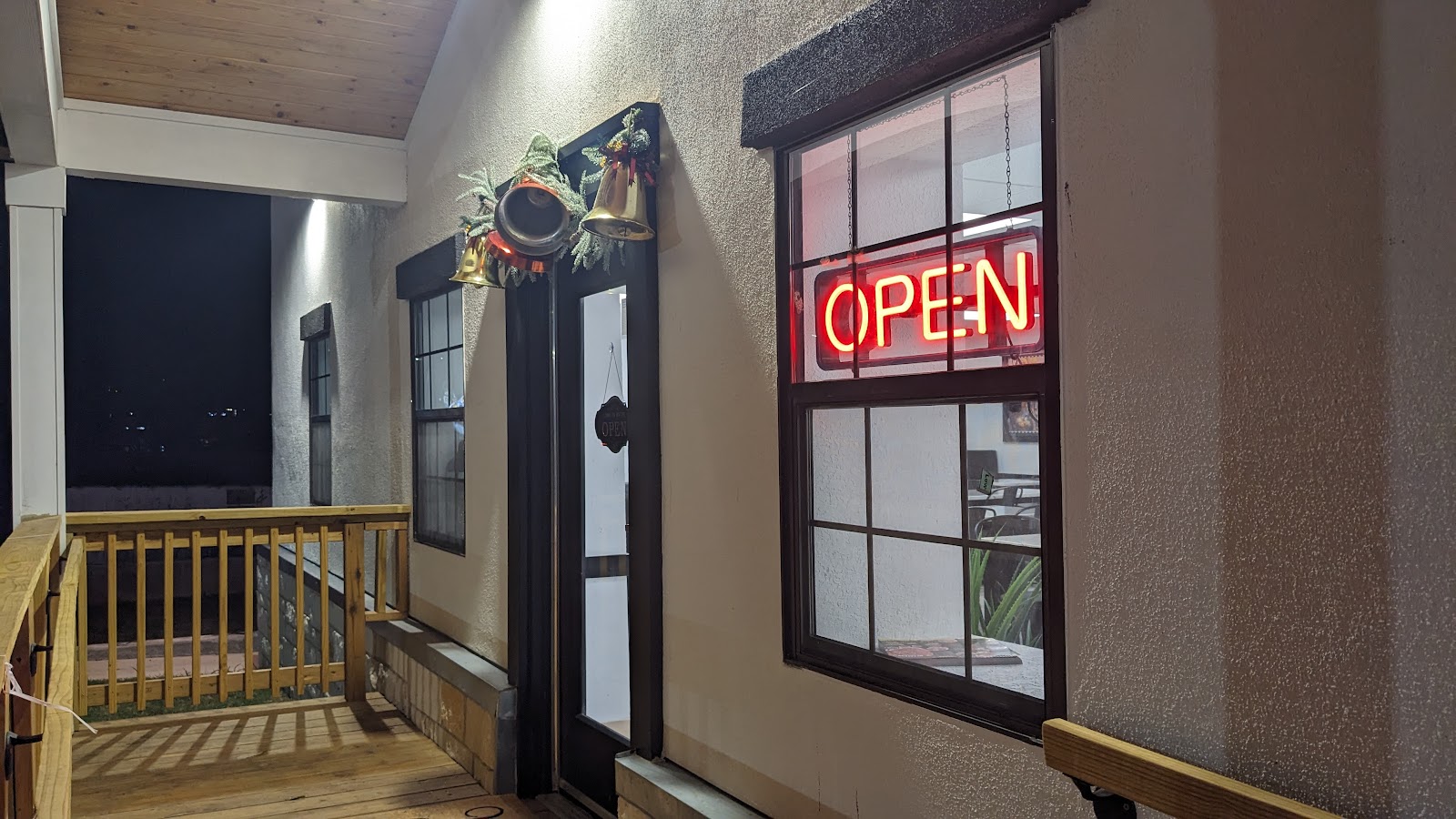 Front entrance with neon open sign at night