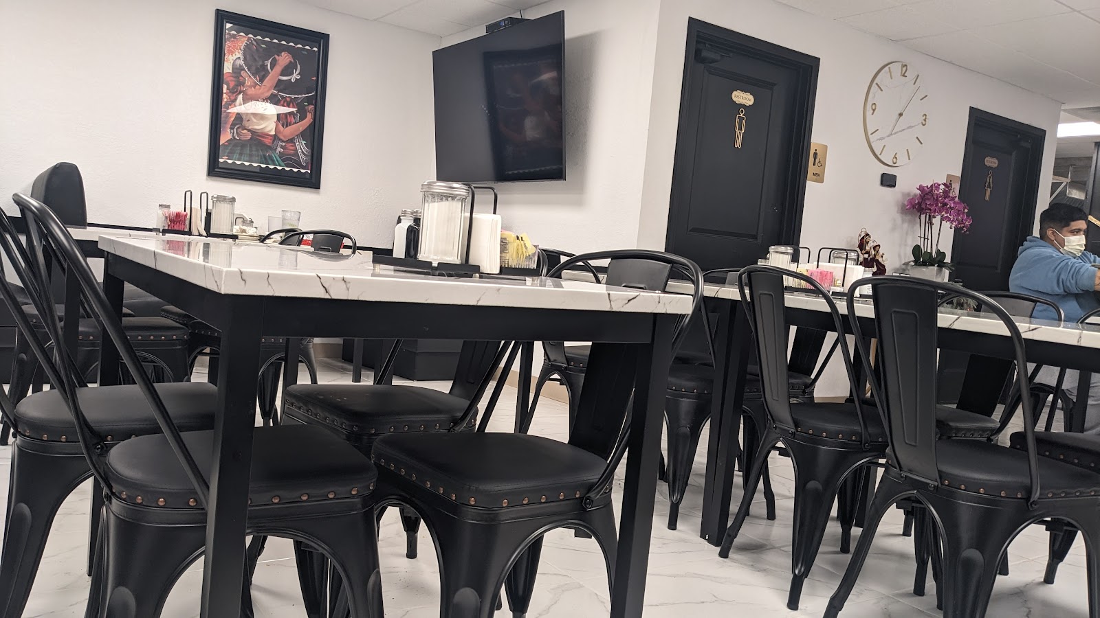 Dining room with restrooms and clock